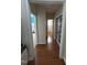 Hallway with hardwood flooring connecting various rooms, including a bedroom and bathroom at 3713 Coach Lantern Ave Ave, Wake Forest, NC 27587