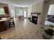 Open-concept kitchen with a fireplace, an island, and a dining area with plenty of natural light at 3713 Coach Lantern Ave Ave, Wake Forest, NC 27587