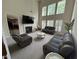 Bright living room featuring high ceilings, large windows, a fireplace, and comfortable seating at 3713 Coach Lantern Ave Ave, Wake Forest, NC 27587