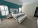 Spacious main bedroom featuring bright teal accent wall, white furniture, and ample natural light at 3713 Coach Lantern Ave Ave, Wake Forest, NC 27587