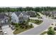 Aerial view of a well-maintained home with lush landscaping, a paved driveway, and a two-car garage at 437 Henmore Brook Dr Dr, Cary, NC 27519