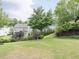 Spacious backyard with a healthy green lawn, elegant trees, and tasteful landscaping providing a private retreat at 437 Henmore Brook Dr Dr, Cary, NC 27519
