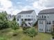 Back of a three-story home featuring a well maintained lawn and foliage around the property's border at 437 Henmore Brook Dr Dr, Cary, NC 27519