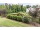 Picturesque backyard featuring a tranquil pond, lush greenery, and privacy fencing for a serene outdoor experience at 437 Henmore Brook Dr Dr, Cary, NC 27519
