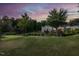 Expansive backyard featuring a lush green lawn and mature trees, creating a serene and private outdoor space at 437 Henmore Brook Dr Dr, Cary, NC 27519