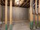 Unfinished basement featuring a concrete floor and exposed ceiling beams and pipes at 437 Henmore Brook Dr Dr, Cary, NC 27519