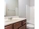 Neutral bathroom featuring a tub, toilet, and vanity with mirror and dark wood at 437 Henmore Brook Dr Dr, Cary, NC 27519