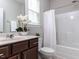 Bathroom showcasing a dark wood vanity, tub/shower combo, and white accents at 437 Henmore Brook Dr Dr, Cary, NC 27519