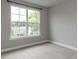 Neutral bedroom featuring a large window offering neighborhood views and natural light at 437 Henmore Brook Dr Dr, Cary, NC 27519