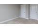 Neutral bedroom showcasing two doors and neutral carpet and trim at 437 Henmore Brook Dr Dr, Cary, NC 27519