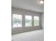 Spacious bedroom with neutral walls, carpeting, and multiple windows for natural light at 437 Henmore Brook Dr Dr, Cary, NC 27519
