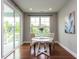 Bright dining area featuring hardwood floors, a stylish table, and view of the backyard at 437 Henmore Brook Dr Dr, Cary, NC 27519