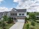 Beautiful home with a well-manicured lawn, brick and siding exterior, and a spacious driveway leading to a two-car garage at 437 Henmore Brook Dr Dr, Cary, NC 27519