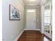 Inviting foyer with hardwood floors, neutral paint, crown molding, and a stylish floral artwork creating a welcoming atmosphere at 437 Henmore Brook Dr Dr, Cary, NC 27519