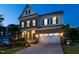 Charming home with manicured lawn, two-car garage, brick accents, and a covered front porch, creating an inviting curb appeal at 437 Henmore Brook Dr Dr, Cary, NC 27519