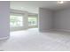 Bright, open-concept living room features neutral paint and carpet throughout at 437 Henmore Brook Dr Dr, Cary, NC 27519
