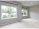 Bright room with large windows overlooking backyard views and neutral carpeting at 437 Henmore Brook Dr Dr, Cary, NC 27519