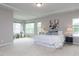Spacious main bedroom with trey ceilings, seating area, and many windows at 437 Henmore Brook Dr Dr, Cary, NC 27519