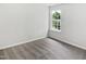 Bright, vacant bedroom featuring neutral carpet, base trim, and a window providing ample natural light at 4509 Cobble Creek Ln, Raleigh, NC 27616