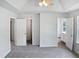 Spacious bedroom featuring a tray ceiling, neutral carpet, and ample natural light at 4509 Cobble Creek Ln, Raleigh, NC 27616