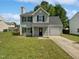 Charming two-story home with an attached garage and a well-maintained lawn on a sunny day at 4509 Cobble Creek Ln, Raleigh, NC 27616