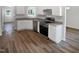 Bright kitchen featuring white cabinets, stainless steel appliances, and granite countertops at 4509 Cobble Creek Ln, Raleigh, NC 27616
