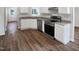 Bright kitchen featuring white cabinets, stainless steel appliances, and granite countertops at 4509 Cobble Creek Ln, Raleigh, NC 27616