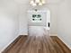 Living room view into another room with archway and laminate flooring at 4509 Cobble Creek Ln, Raleigh, NC 27616