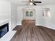 Spacious living room with hard wood flooring, large fireplace, and arched entry to dining area at 4509 Cobble Creek Ln, Raleigh, NC 27616