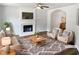 Bright living room featuring a fireplace, hardwood floors, neutral decor, and comfortable seating at 4509 Cobble Creek Ln, Raleigh, NC 27616