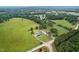 Expansive aerial view of property with lush green pasture, mature trees, and charming residences on a sprawling estate at 4600 Smithfield Rd, Wendell, NC 27591