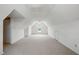 Bright attic area featuring white walls and ceiling, carpeting, and a window at 4600 Smithfield Rd, Wendell, NC 27591