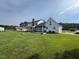 Spacious backyard with a large screened-in porch, a two-car garage, and mature trees at 4600 Smithfield Rd, Wendell, NC 27591