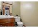 Bathroom with toilet, sink, wooden cabinets and framed mirror at 4600 Smithfield Rd, Wendell, NC 27591