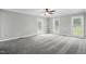 An expansive bedroom is carpeted and features three windows to let in plenty of natural light at 4600 Smithfield Rd, Wendell, NC 27591