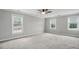 This carpeted bedroom features three windows and plenty of open space at 4600 Smithfield Rd, Wendell, NC 27591