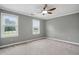A carpeted bedroom features two windows and a ceiling fan with lights at 4600 Smithfield Rd, Wendell, NC 27591