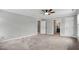 The carpeted bedroom features a ceiling fan, and doorway to the bathroom at 4600 Smithfield Rd, Wendell, NC 27591