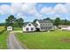 Beautiful two-story white farmhouse with black shutters, a charming front porch, and a lush green lawn at 4600 Smithfield Rd, Wendell, NC 27591