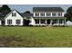 Charming two-story home with black shutters, white siding, a covered porch, and green lawn at 4600 Smithfield Rd, Wendell, NC 27591