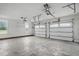 Spacious three car garage with natural light from side windows and white painted walls at 4600 Smithfield Rd, Wendell, NC 27591