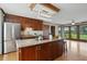 Kitchen island with seating, wooden cabinets, stainless appliances, and view of backyard at 4600 Smithfield Rd, Wendell, NC 27591