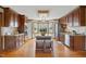Kitchen with center island with seating, wooden cabinets, stainless appliances, and granite countertops at 4600 Smithfield Rd, Wendell, NC 27591