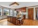 Kitchen island with seating, wooden cabinets, stainless appliances, and view of backyard at 4600 Smithfield Rd, Wendell, NC 27591