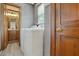 Laundry room with wooden door, white washer and dryer, and view into bathroom at 4600 Smithfield Rd, Wendell, NC 27591