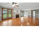 Inviting living room featuring fireplace, built-in shelves, French doors, and gleaming hardwood floors at 4600 Smithfield Rd, Wendell, NC 27591
