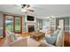 Cozy living room featuring a brick fireplace, wood floors, built-in shelves, and comfortable seating at 4600 Smithfield Rd, Wendell, NC 27591