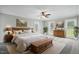 Spacious bedroom features a ceiling fan, two windows, and a wooden chest with a light grey carpet at 4600 Smithfield Rd, Wendell, NC 27591