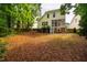 Spacious backyard featuring a well-maintained lawn, patio area, and mature trees at 507 Vatersay Dr, Apex, NC 27502