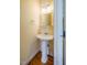 Powder room featuring a pedestal sink with a silver faucet and light fixture at 507 Vatersay Dr, Apex, NC 27502